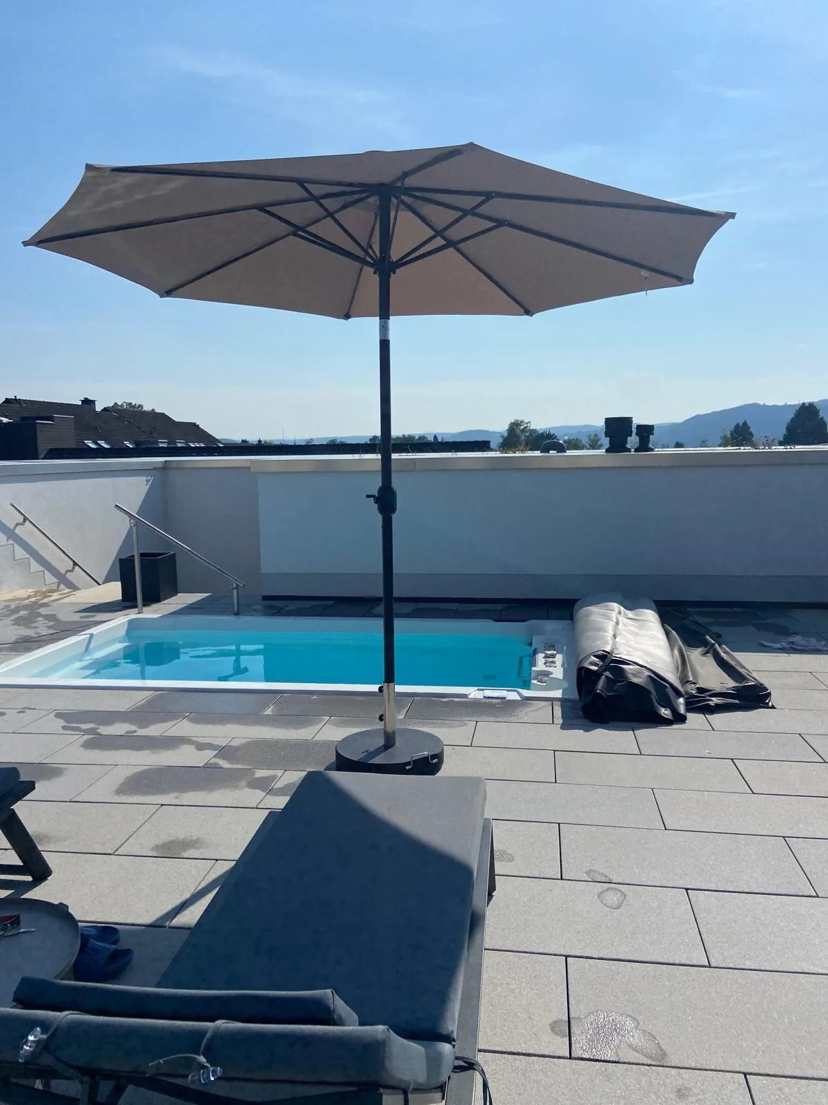 INFINITAS swim spa fully inground in a large-format paved terrace